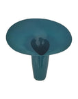 Teal-colored vase with a textured surface on a white background