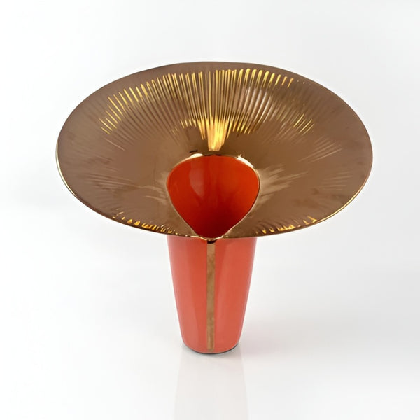 Decorative vase with gold rim and red body on a white background