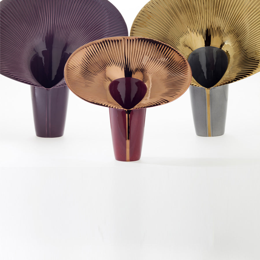 Three decorative vases with unique designs on a white background