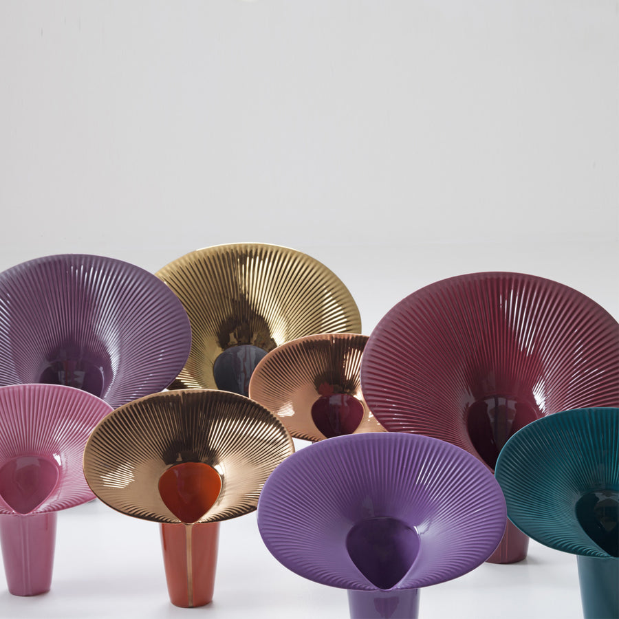 Colorful metallic vases on a white background