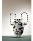 Decorative vase with abstract design and handles on a plain background