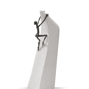 A Butzon Bercker sculpture of a man climbing on a rock, symbolizing the belief that everything is possible.