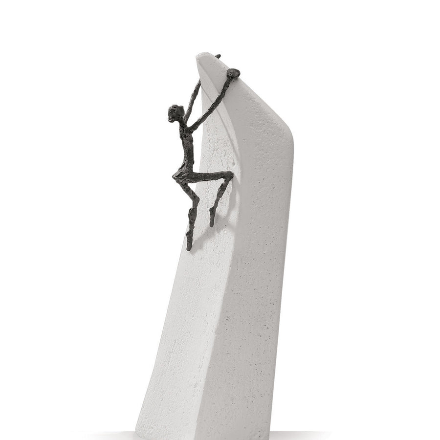 A Butzon Bercker sculpture of a man climbing on a rock, symbolizing the belief that everything is possible.