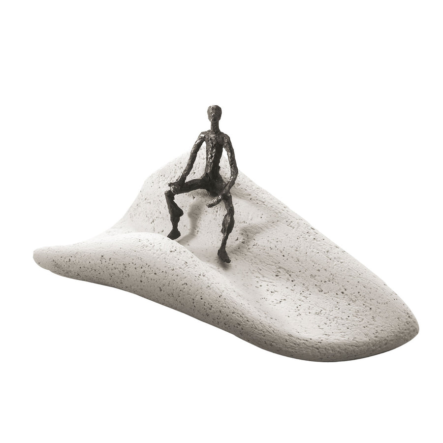 A captivating Butzon & Bercker Sculpture Intuition of a man sitting on a sand dune, crafted by Butzon Bercker.