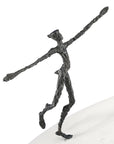A Butzon Bercker sculpture of a man standing on top of a snow, named "On The Way To New Horizons".