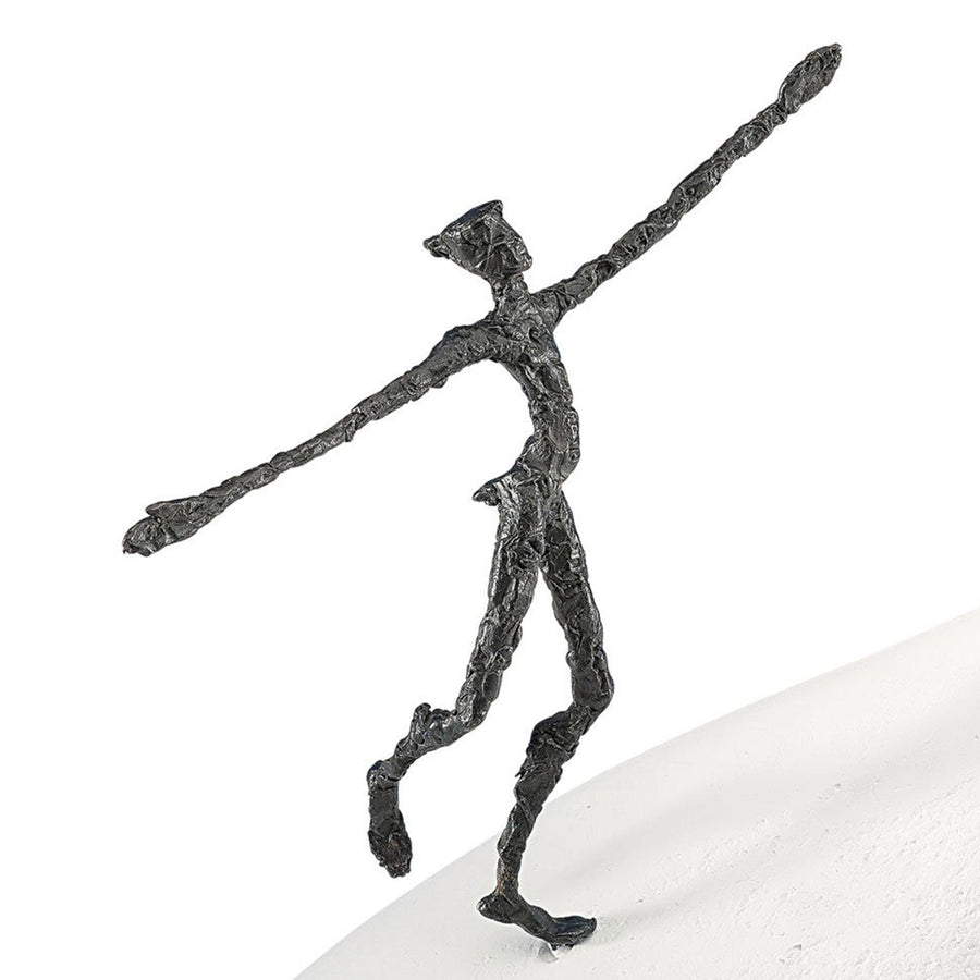 A Butzon Bercker sculpture of a man standing on top of a snow, named "On The Way To New Horizons".