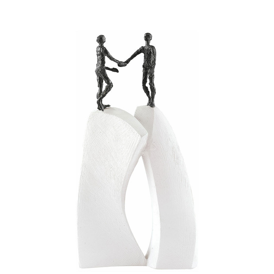 Two Butzon & Bercker Sculpture Shake Hands figurines on top of a white pedestal, symbolizing unity.