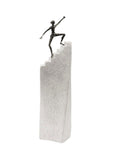 A Butzon Bercker sculpture of a motivated man on top of a stair, symbolizing success.