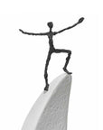 A Butzon Bercker sculpture of The Future Now, a man standing on top of a surfboard, captivating as an artwork.