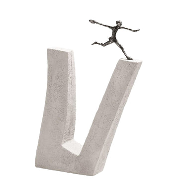 A Butzon &amp; Bercker Sculpture Who does not Dare brand sculpture of a brave man running on top of a concrete block showcasing inspiring art.