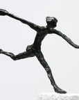 A Butzon Bercker sculpture named "Who does not Dare" of a woman displaying bravery as she runs gracefully on top of a pedestal.