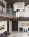 Modern interior with a large chandelier and stylish furniture.