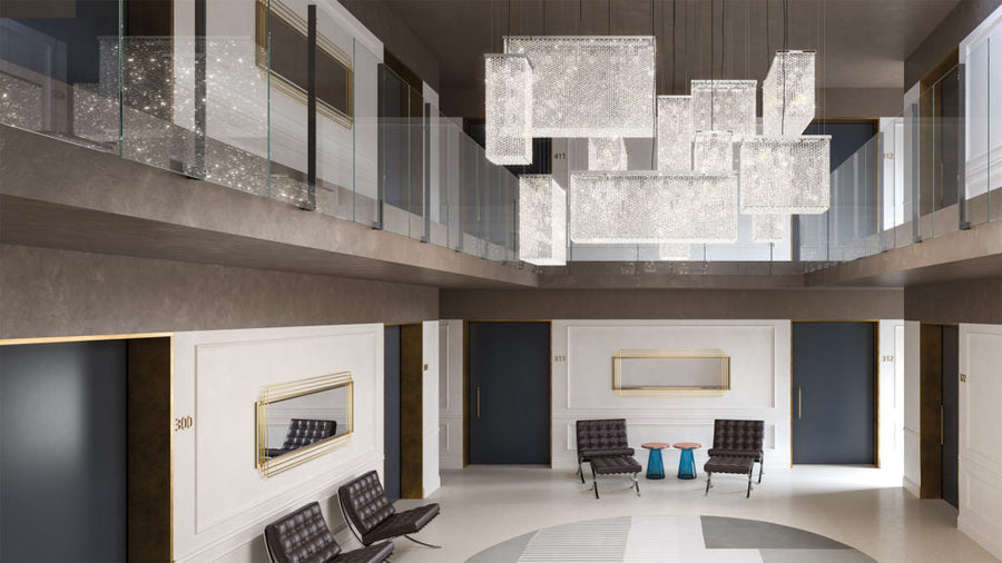 Modern interior with a large chandelier and stylish furniture.
