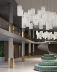 Modern interior with a large chandelier, green seating area, and living wall.