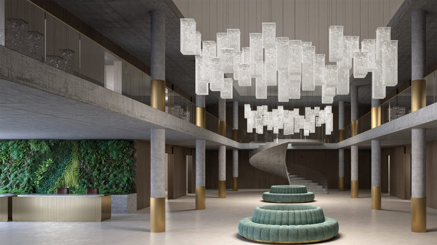 Modern interior with a large chandelier, green seating area, and living wall.
