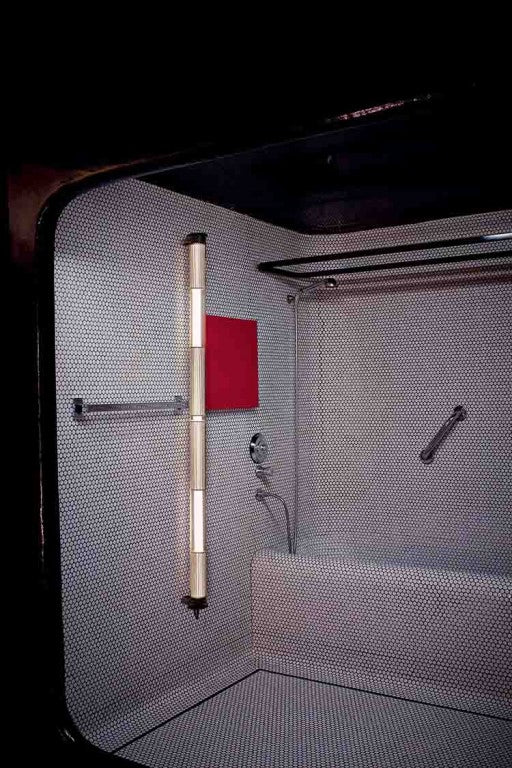 In the tube wall and vertical light from DCW Editions in a bathroom