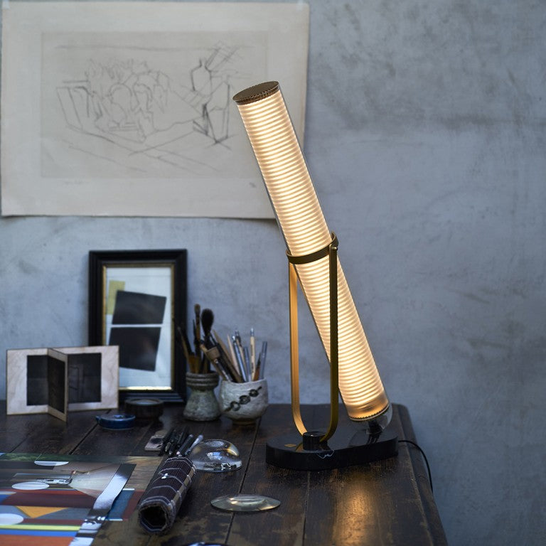 La Lampe Frechin table lamp by DCW Editions on a working table of an artist