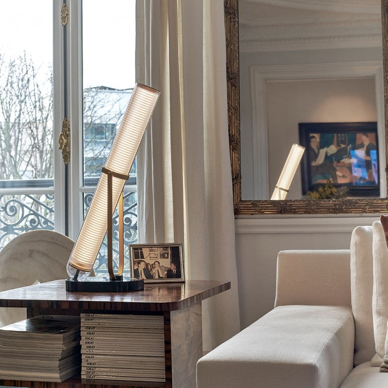 La Lampe Frechin table lamp by DCW Editions on a side table in a classical style living room.