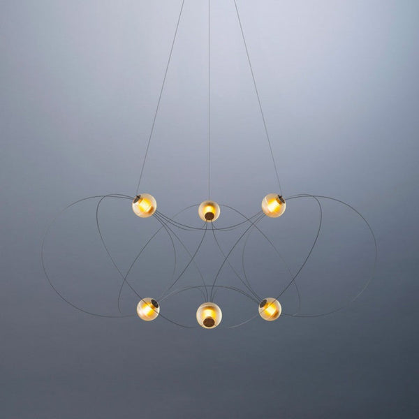 Modern chandelier with six hanging lights on a gray background from DCW Editions