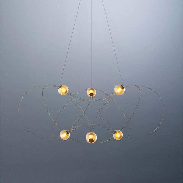 Modern chandelier with five spherical lights on a gray background from DCW Editions
