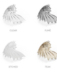 Four shell-shaped glass elements from Italamp's Kaleido collection in different finishes on a white background