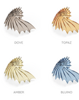 Four shell-shaped glass elements from Italamp's Kaleido collection in different finishes on a white background