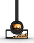 A modern black metal wood-burning stove with a circular firebox showing a glowing fire, a tall chimney pipe, and a rectangular base holding stacked firewood logs, isolated on a white background.