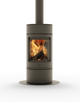 A modern cylindrical wood-burning stove with a visible fire inside, shown on a clean white background. The stove has a matte dark gray finish and a matching vertical chimney pipe extending upward.