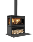 A modern black metal wood-burning stove with a visible fire inside and stacked logs in the lower shelf, shown on a plain white background.