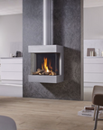 A modern wall-mounted gas fireplace with a stainless steel surround and visible flames, set into a contemporary kitchen interior with light wood flooring and white cabinetry.
