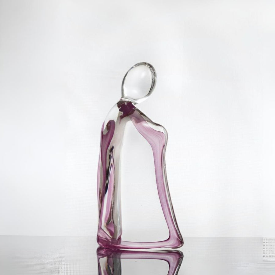 Glass sculpture of a woman with a purple tint on a white background titled HER from Duccio Di Segna, available at Spacio retail stores in Mumbai & Kolkata. 