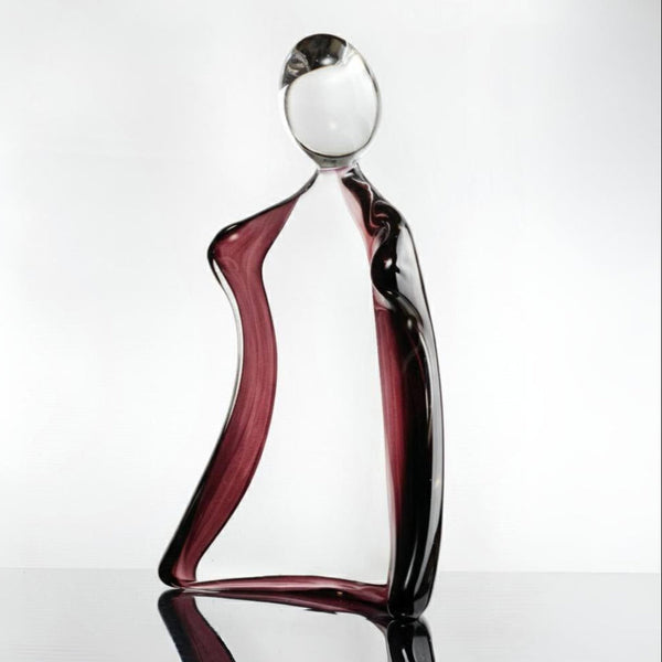 Glass sculpture of a man with a violet tint on a white background titled HIM from Duccio Di Segna, available at Spacio retail stores in Mumbai & Kolkata. 