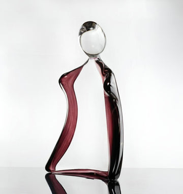 Glass sculpture of a man with a violet tint on a white background titled HIM from Duccio Di Segna, available at Spacio retail stores in Mumbai & Kolkata. 