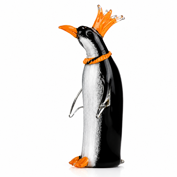 Glass penguin figurine with orange crown on a white background