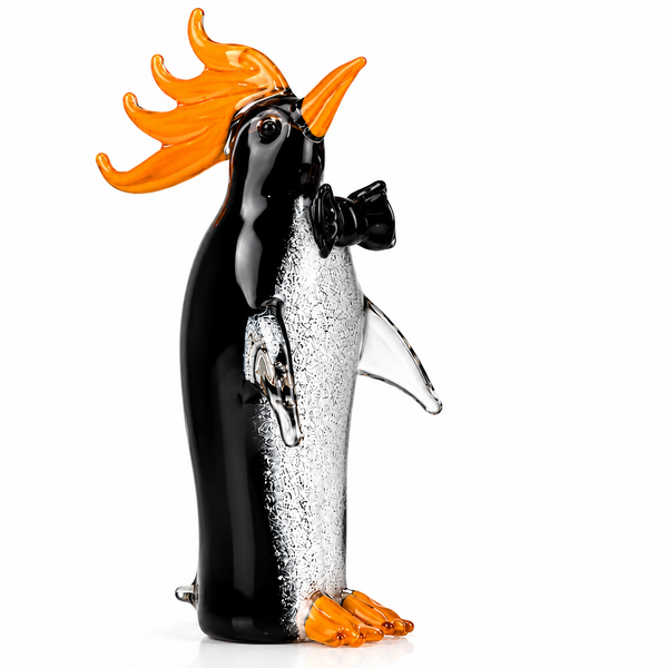 Glass penguin figurine with orange hair and bow tie on a white background