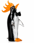 Glass penguin figurine with orange hair and bow tie on a white background
