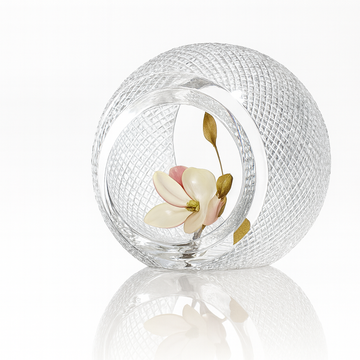 Diamond cut crystal sculptural vase containing a decorative flower on a white background from Duccio Di Segna available at Spacio retail stores in Mumbai & Kolkata. 