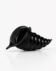 A crystal black spiral shell-shaped decorative object, resembling a stylized seashell or sculptural vessel, photographed on a clean white studio background.