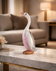 Decorative duck figurine on a marble coffee table in a living room setting