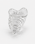 A clear textured crystal seashell-shaped container, photographed on a clean light gray background.