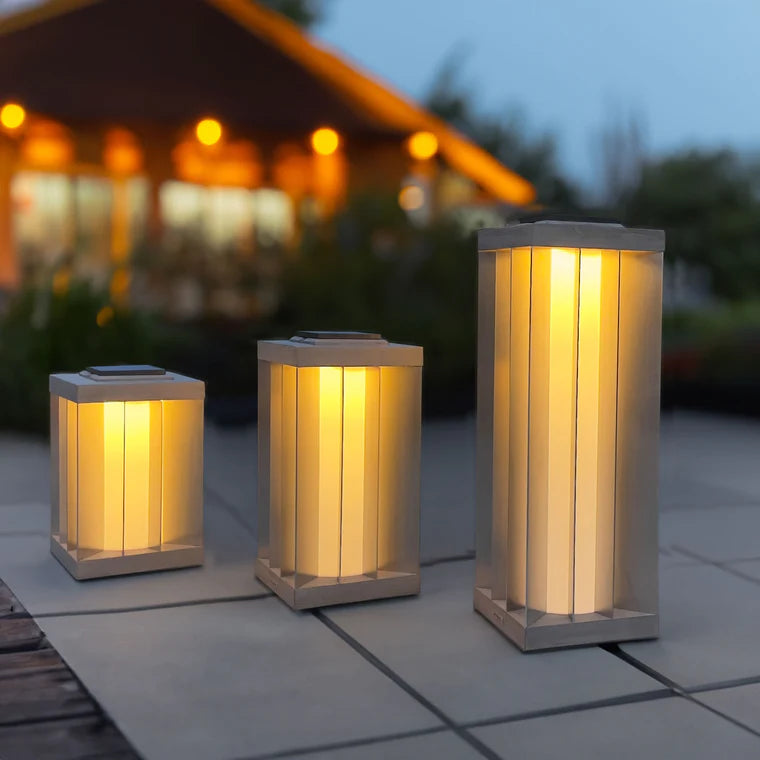 Set of three indoor outdoor solar lantern lights on a patio with a blurred background  by Les Jardins available at Spacio retail stores in Mumbai & Kolkata. 