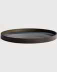Round wooden tray on a light gray background