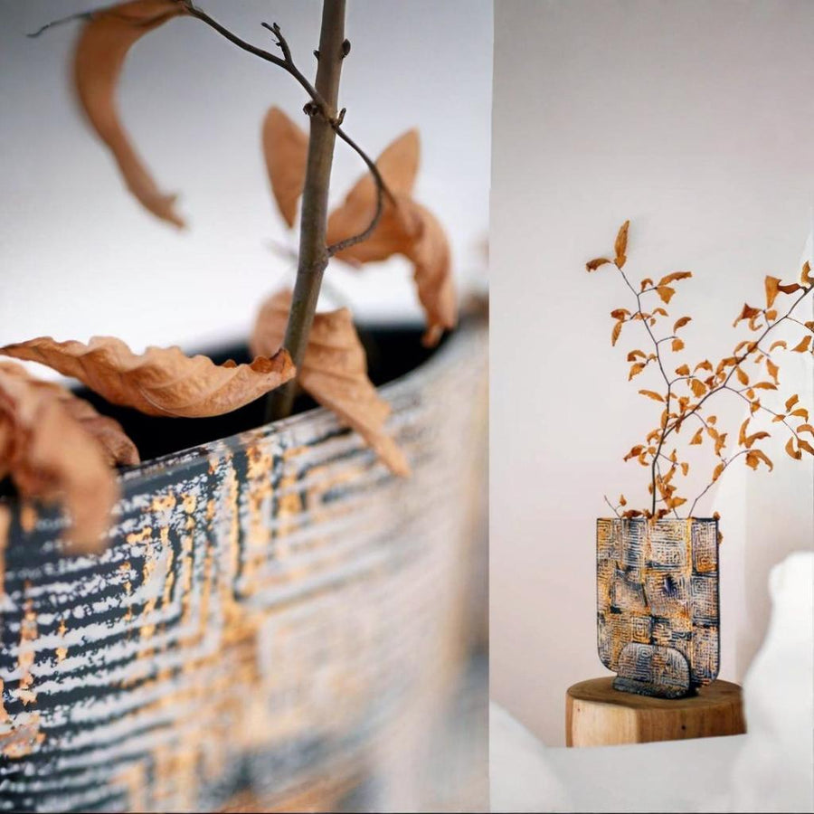 Decorative vase with autumn leaves on a textured surface by Evans Atelier available at Spacio retail stores in Mumbai & Kolkata. 