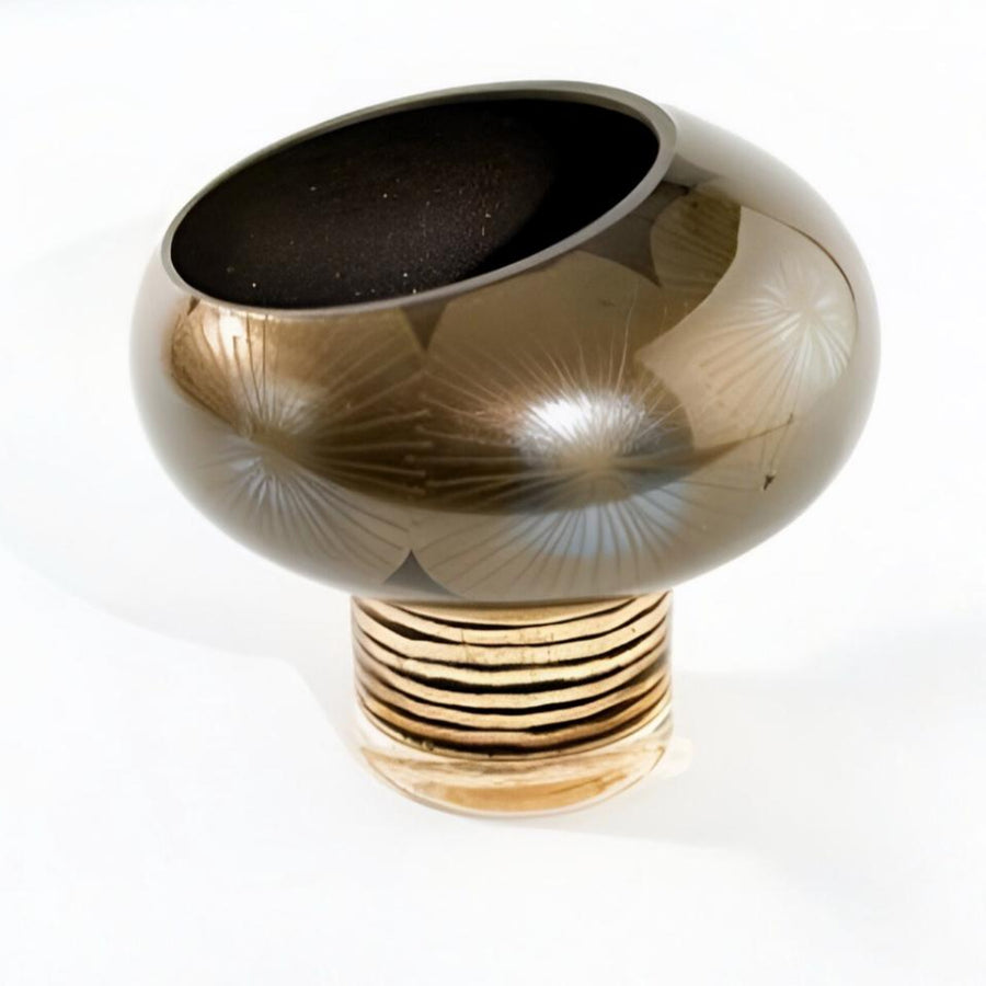 Decorative vase with gold and black design on a white background  by Evans Atelier available at Spacio retail stores in Mumbai & Kolkata. 