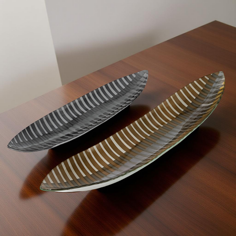 Two glass plates with decorative patterns on a wooden surface by Evans Atelier available at Spacio retail stores in Mumbai & Kolkata. 