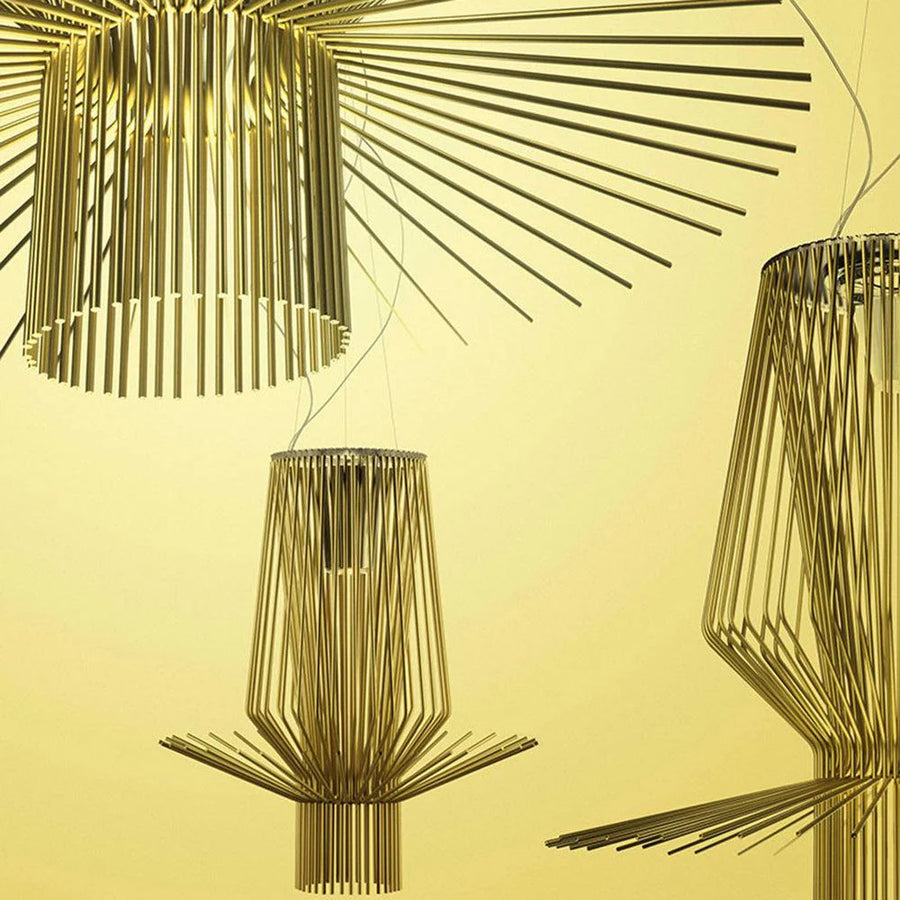 Gold pendant lights against a yellow background