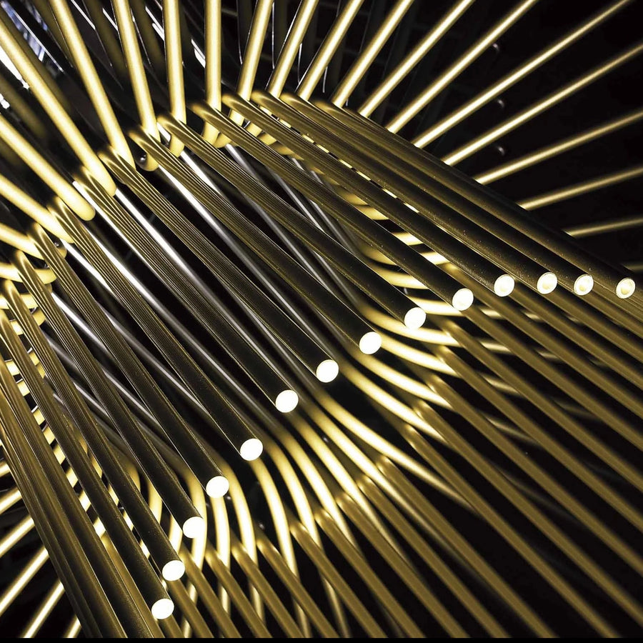 Close-up of gold metal rods arranged in a circular pattern