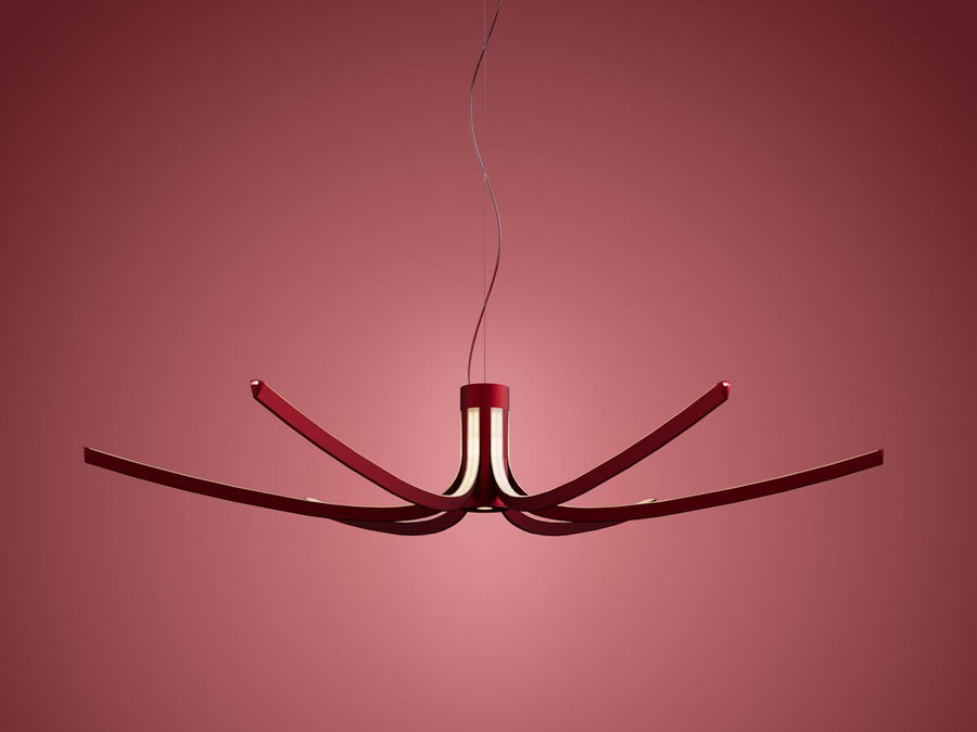 Modern chandelier with red accents on a pink background