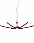 Modern suspension light with red accents on a white background from Foscarini available at Spacio retail stores in Mumbai & Kolkata. 