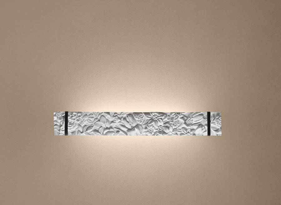 Decorative wall light fixture with textured wall on a beige background